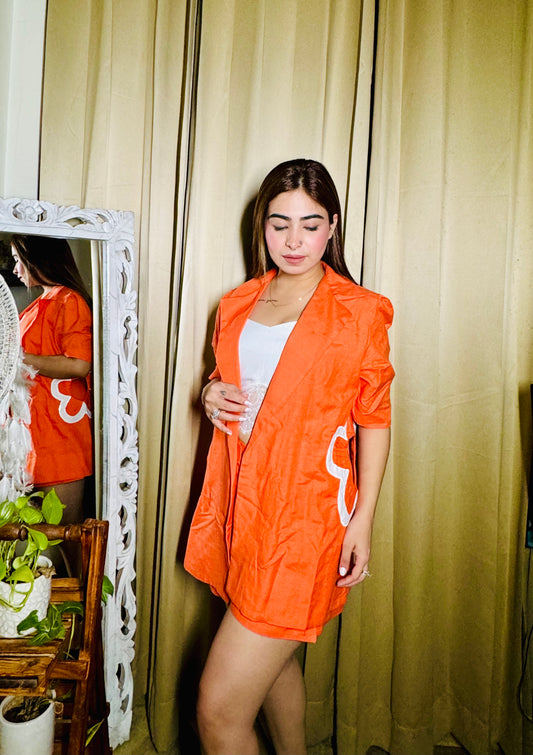 Sunset Chic: Vibrant Orange Blazer with Shorts and Intricate Appliqué